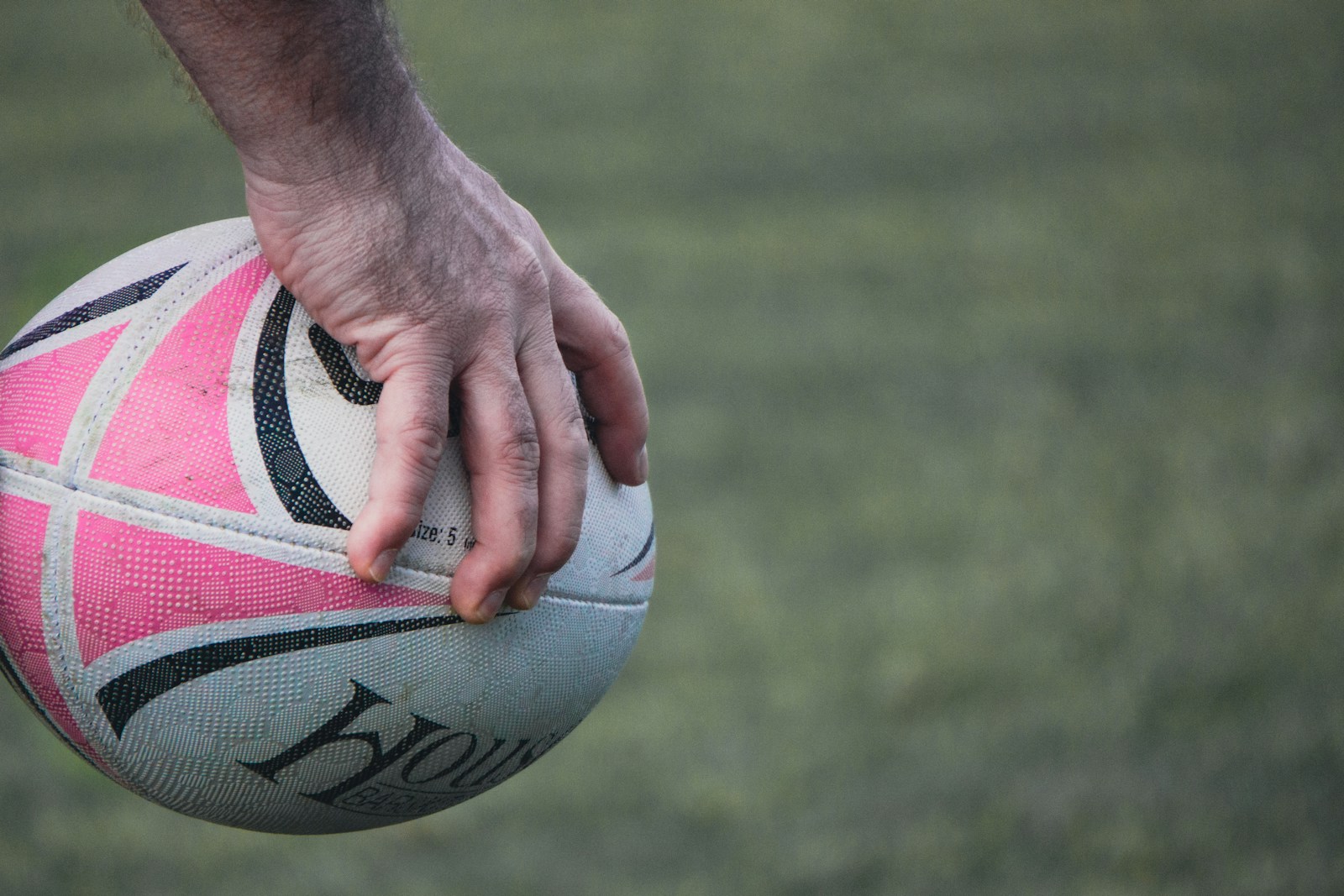 a close up of a person holding a soccer ball